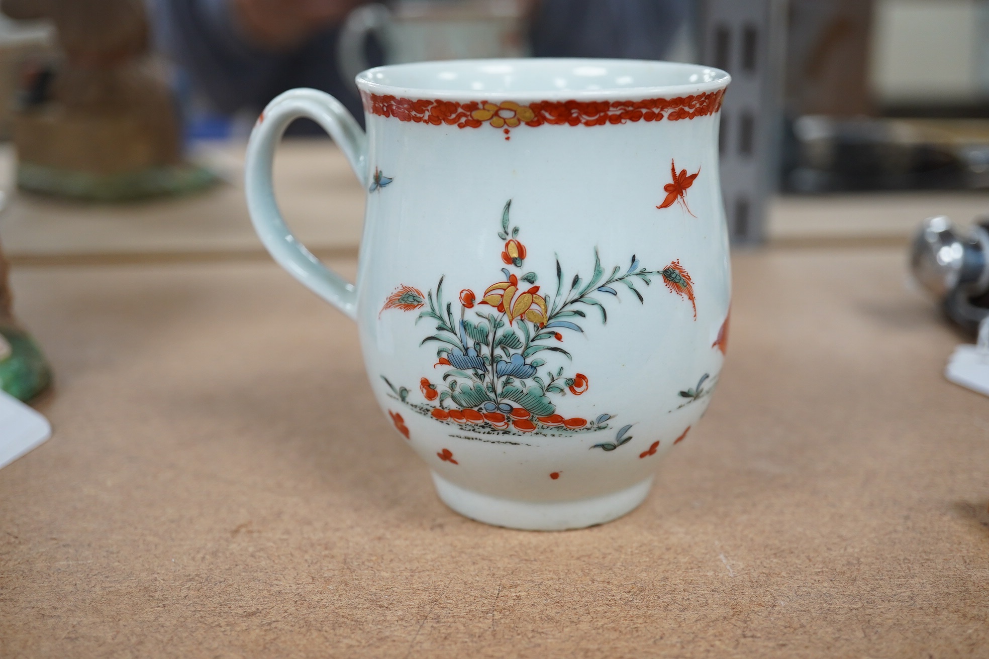 An 18th century Worcester polychrome porcelain mug decorated with quails, 9cm high. Condition - fair, chip to top rim